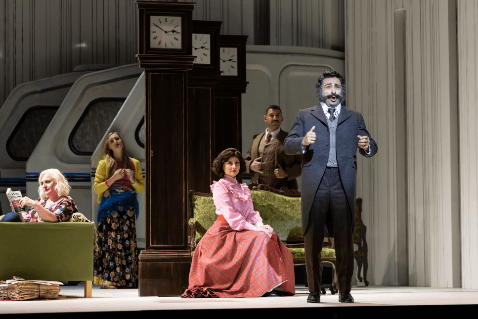 Opera performers on stage in period costumes during a theatrical performance