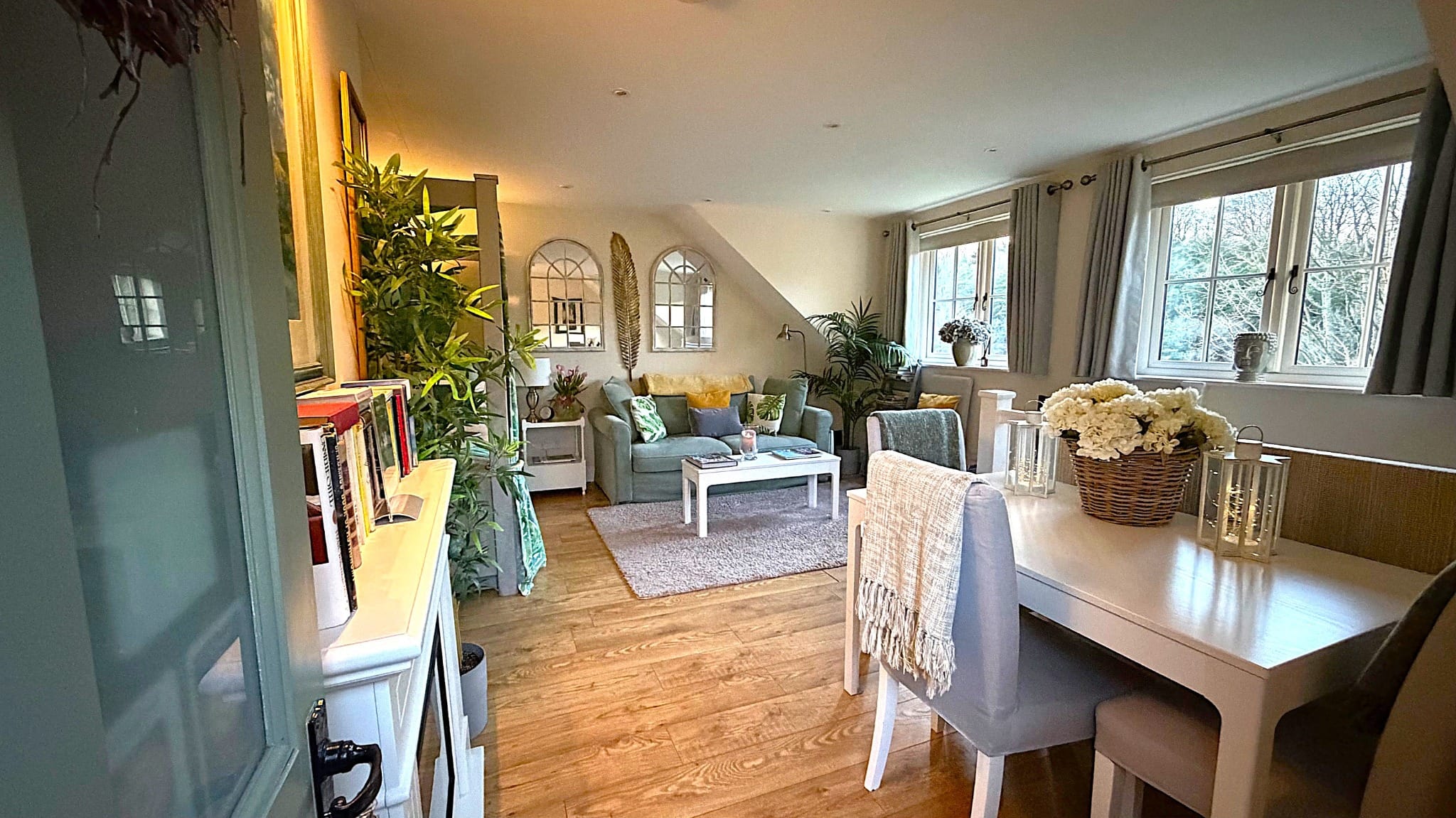 Cosy holiday cottage living and dining room interior with woodland views