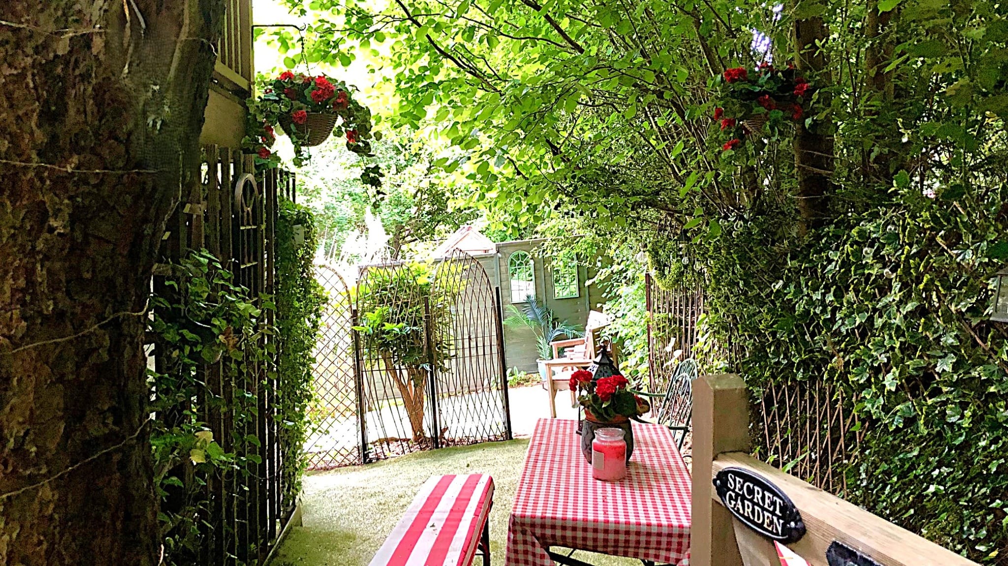 Private holiday cottage garden seating area with woodland surroundings