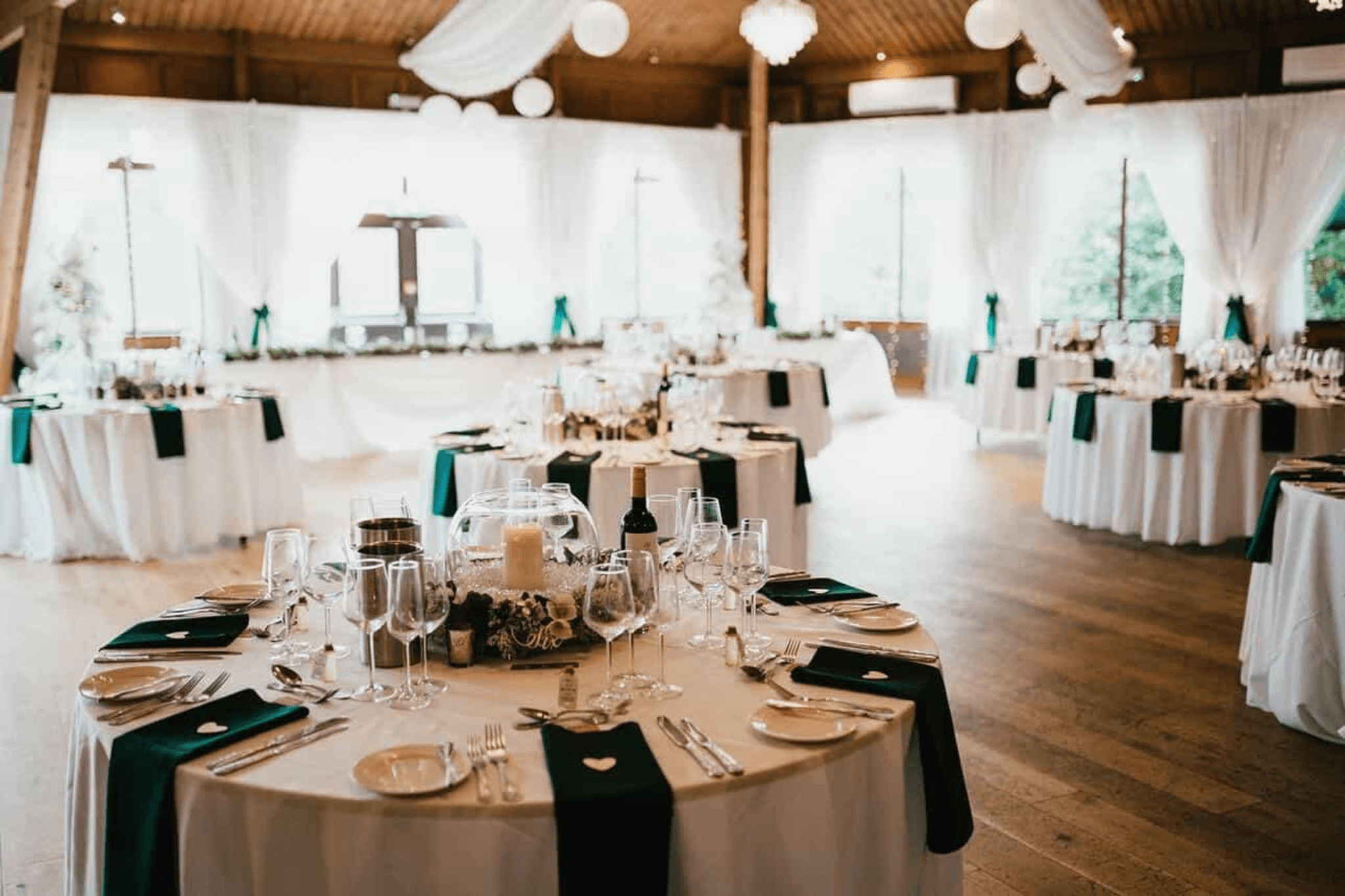 Elegant wedding reception venue with decorated tables and white draped interior