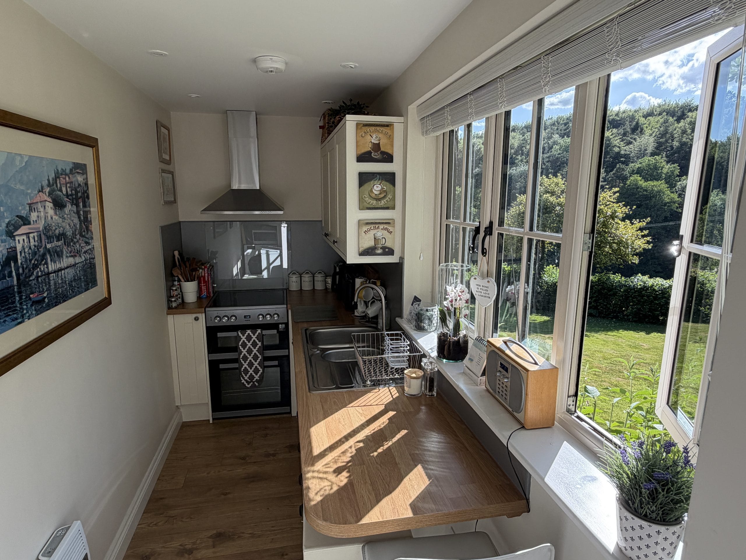 Self-Catering Holiday Cottage Accommodation In Sussex Kitchen with breakfast bar and woodland views