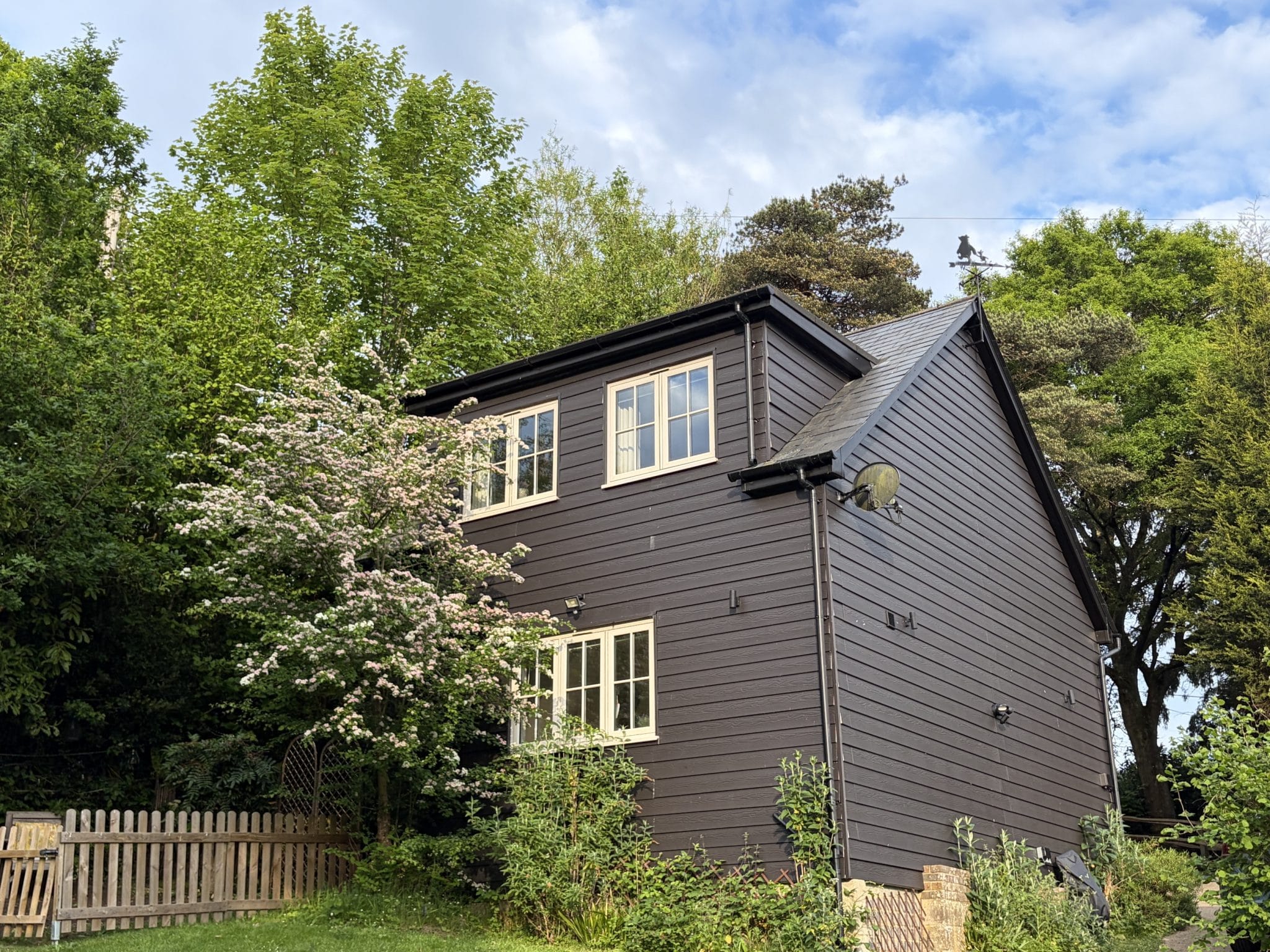 Self-Catering Holiday Cottage Accommodation In Sussex Exterior of The Nest Danehill woodland cottage surrounded by trees